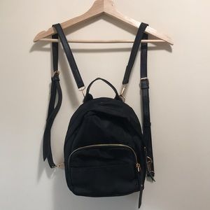 Black 4-pocket mini backpack with gold accents